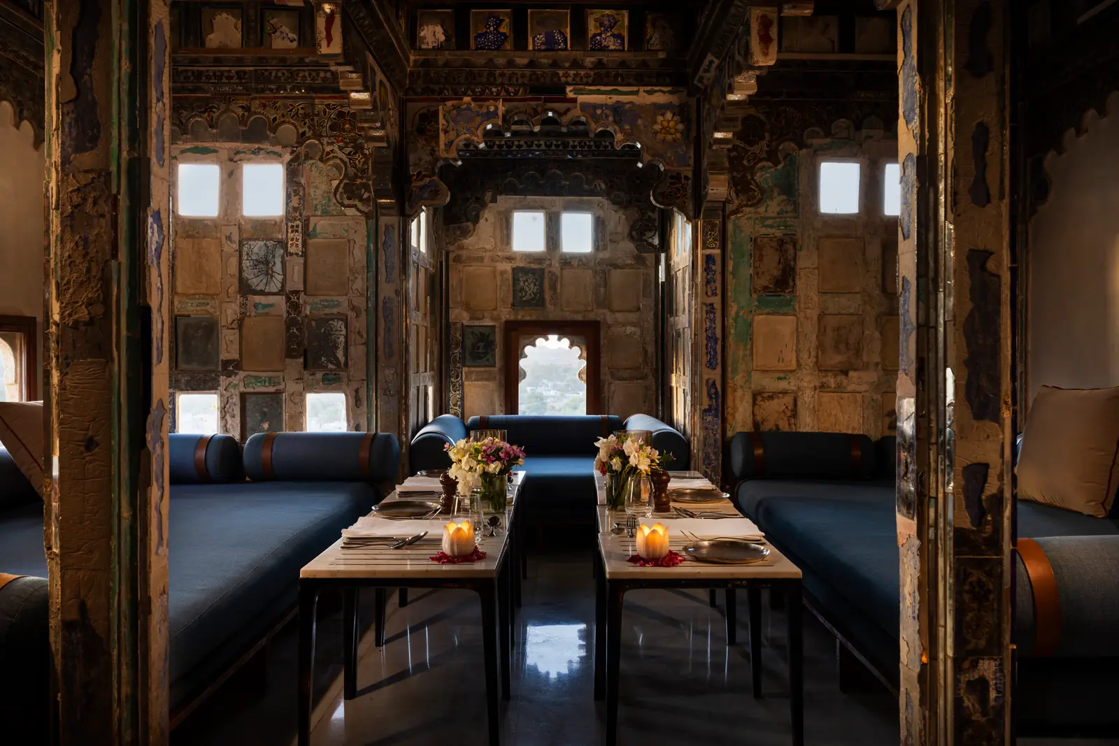 Restored hilltop fort palace above its gardens at sunset in the Aravalli hills near Udaipur