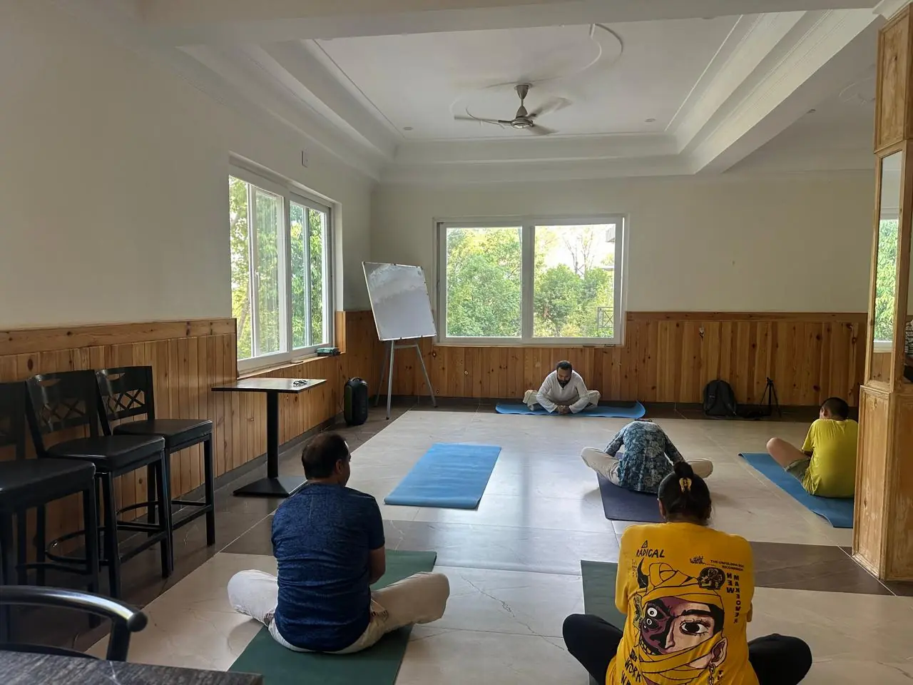 Guesthouse on a forested hillside facing the snowy Dhauladhar range near Palampur, Himachal Pradesh