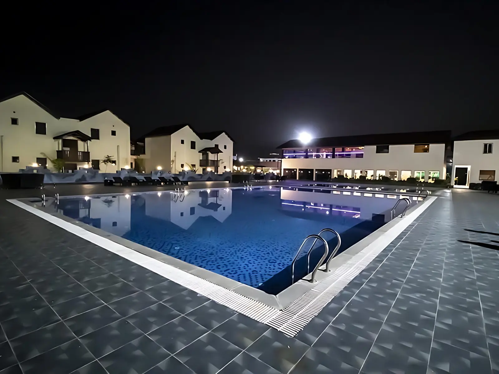 Aerial view at sunrise of a red-roofed Ayurveda resort with a pool near Mount Abu, Rajasthan